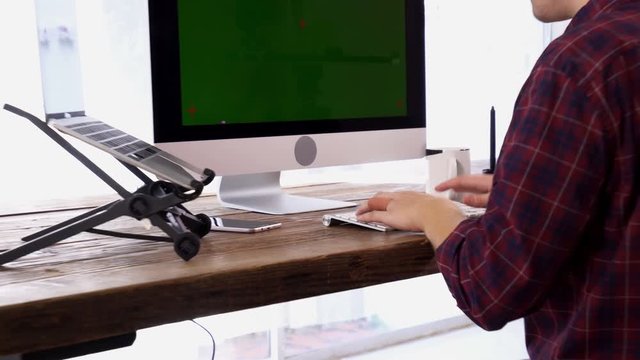 Young Caucasian Programmer Working on a Computer at His Home Office