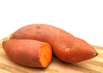 Sweet potatoes halves on wooden surface