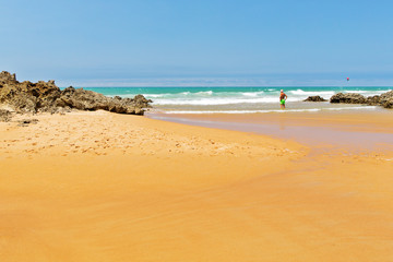 View of the ocean from the sandy beach in summer day