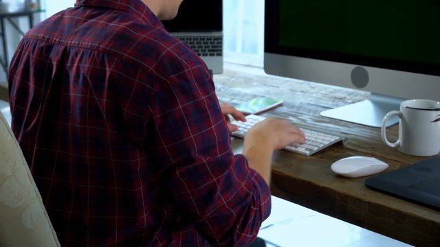 Zoom out with the caucasian male is typing on wireless keyboard