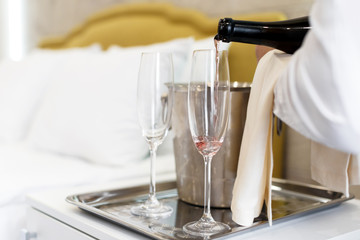 Honeymoon concept. Champagne bucket near bed in a hotel room