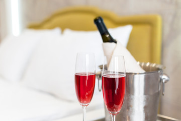 Honeymoon concept. Champagne bucket near bed in a hotel room