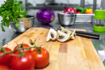 Various vegetables and kitchenware on a kitchen table in a restaurant