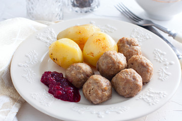 Swedish meatballs with cream sauce and cranberry jam, horizontal