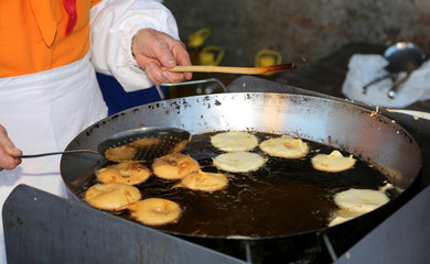 pancake made with apples in a big pot full of olive oil