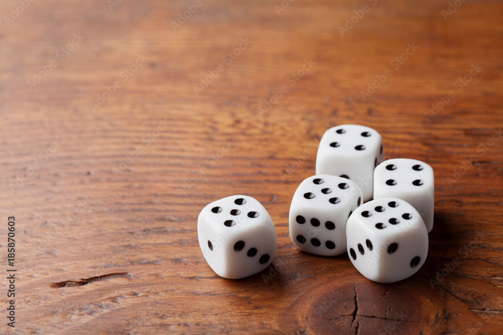 Wall mural game of chance concept. gambling devices. white dice on rustic wooden board. copy space for text.