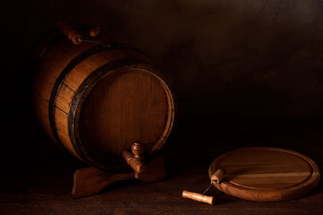  a small wooden wine bar, barrel on the legs and a wooden crane on a wooden background with a glass...