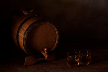 a small wooden wine bar, barrel on the legs and a wooden crane on a wooden background with a glass...