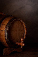 a small wooden wine bar, barrel on the legs and a wooden crane on a wooden background