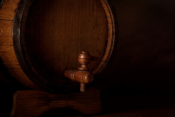 a small wooden wine bar, barrel on the legs and a wooden crane on a wooden background