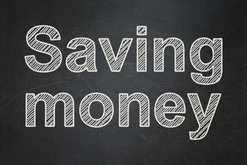 Business concept: text Saving Money on Black chalkboard background