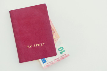 10 euros in the red passport on a white background