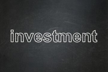 Business concept: text Investment on Black chalkboard background