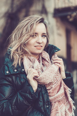 Woman wearing down feather coat and scarf