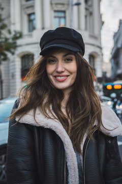 Woman in stylish cap on street