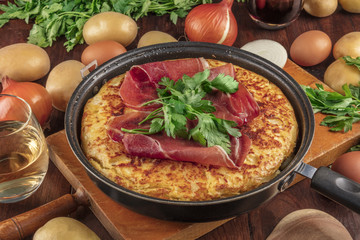 A closeup photo of a Spanish tortilla with ingredients