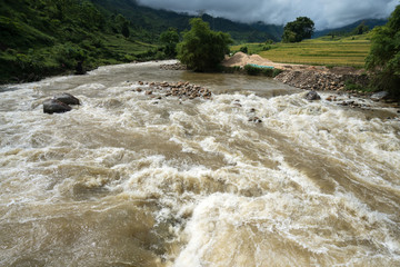 River stream in flood after several days of rain in north Vietnam