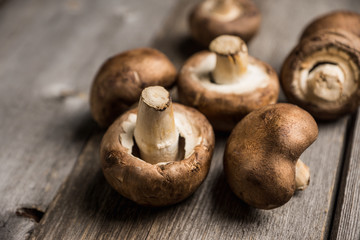 Fresh mushrooms on the rustic wooden background. Selective focus. Shallow depth of field.