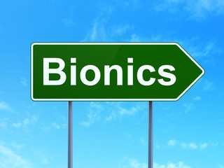 Science concept: Bionics on green road highway sign, clear blue sky background, 3D rendering