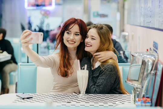 Cheerful women having cocktails