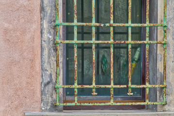 Peeling and rusty grate of old window