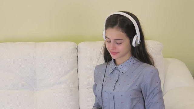 Beautiful girl with headphones listening to music.