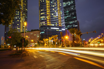 Night scene of modern city with light trails.