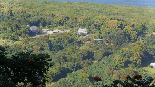 a long shot of the two historic churches on the road to hana, maui