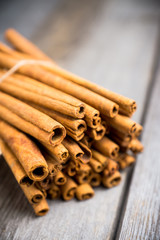 Cinnamon sticks on the rustic wooden background. Selective focus. Shallow depth of field.