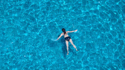 People swimming in the hotel pool on summer day