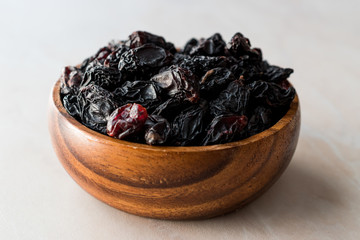 Organic Dried Raw Raisins in Wooden Bowl.