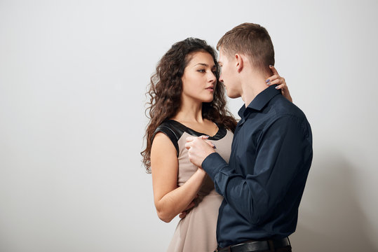 Portrait of young couple posing on white background