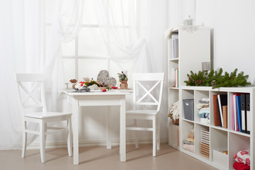 white room interior with christmas decoration, window, table and chair