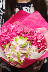 bouquet of hydrangeas in the women's hands.