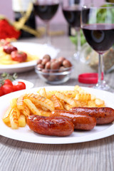 French fries and sausage on the dish