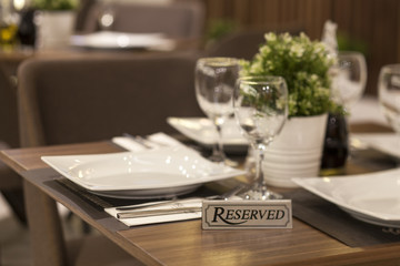 reservation on a dinner table at the restaurant - obrazy, fototapety, plakaty