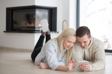 Young Couple using digital tablet on cold winter day
