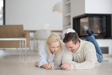 Young Couple using digital tablet on cold winter day