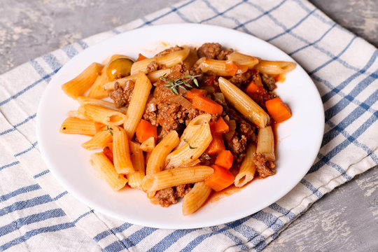 Penne pasta in tomato sauce with meat. Bolognese sauce with italian pasta