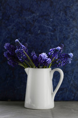 Spring blue flowers in white jug
