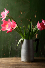 Pink tulips in rustic vase