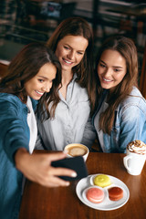 Beautiful Girls In Cafe Taking Selfie Photo On Phone.