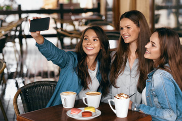 Beautiful Girls In Cafe Taking Selfie Photo On Phone.