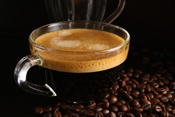 Espresso coffee in a glass cup and coffee beans
