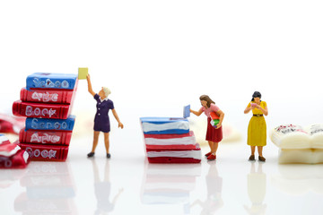 Miniature people :  reading books using as background education or business concept