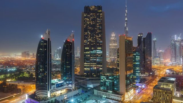 Fantastic nighttime skyline of a big modern city. Scenic aerial view of Dubai downtown skyscrapers and highways with light trails. 4K time lapse. Colouful travel background. 