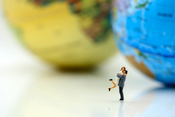 Miniature  people : love couple stand with globe world map balloon background,travel and lovely concept.