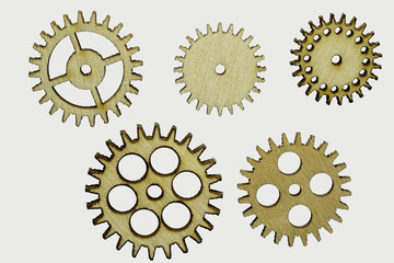 set of five different wooden cog wheels isolated on white background