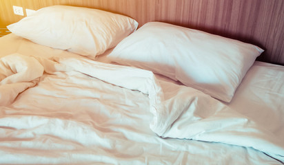 Close up of pillows on the bed after wake up with soft light morning.