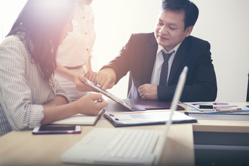 Business team discusses marketing plans or strategic plans in the meeting room.